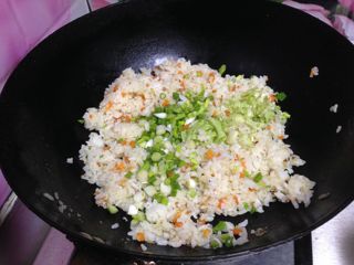 3、米饭“汉堡”,加入盐调味，倒入香葱碎炒匀关火，稍微冷却备用