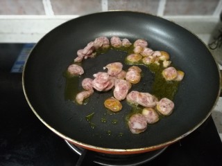 4、虾仁香肠迷你小披萨,放入香肠翻炒几下