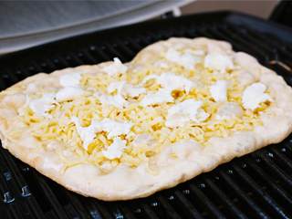 7、玛格丽特披萨,将马苏里拉奶酪球 撕碎，撒在蒙特利杰克芝士上。