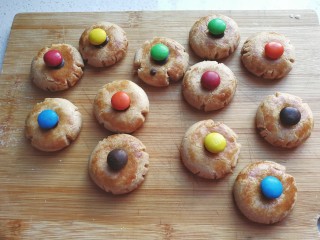 10、万圣节~蜘蛛饼干,黑巧力装裱花袋隔热水融化,然后挤适量在饼干凹处,再摆上m豆沾紧;