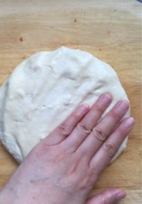 2、夏威夷披萨,取出发酵好的面团按压排气。