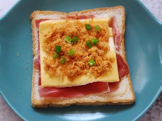 4、肉松培根吐司披萨,用刀切点小香葱叶撒到肉松上面，无需太多。