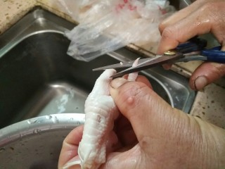 1、百香果泡鸡爪,鸡爪用剪刀剪去爪子