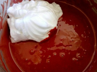 17、红曲蛋糕卷,蛋黄糊中加入3分之一的蛋白。刮刀切拌或者翻拌，用手抽也可以。切记不要画圈搅拌，画圈会消泡，消泡的蛋糕糊会导致蛋糕发不起来。所以这一步很关键哟。