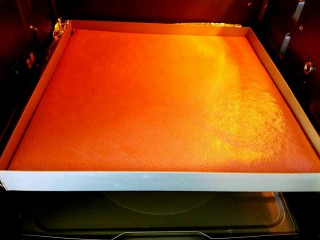 20、红曲蛋糕卷,几分钟后的状态，表面有一些变化了。烤好的蛋糕片出炉前表面摸起来会有一点硬，如果不硬就需要再多烤一会。