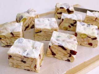 12、坚果雪花酥,放凉后，用锯齿刀把雪花酥切成大小一致的块状，可根据自己的喜好来决定切块的大小。