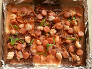 5、吐司披萨,把炒好的料铺上。