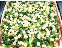 3、腰果菠菜匹萨 ,把面擀成饼，放入抹了一层油的烤盘上，面饼上抹匹萨酱，撒一层马苏里拉奶酪，铺上炒好的菠菜腰果，撒上盐和黑胡椒粉。