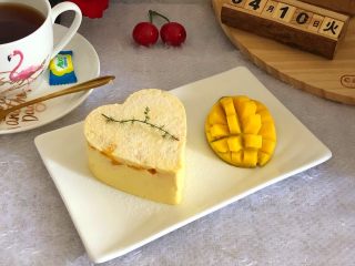 13、芒果慕斯蛋糕,用吹风机吹，或者热毛巾捂都可以脱模，撒上防潮糖粉！自己食用不撒也可以呢！