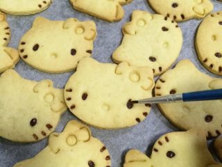 14、hellokitty饼干,用画笔沾上黑巧克力，给kitty猫饼干画上眼睛。
