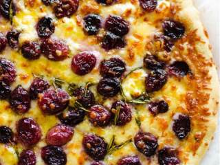 4、芝士烤葡萄披萨,移至烤箱上层，烤1分钟，直到芝士变成棕色并且开始冒泡。然后就可以享用啦！