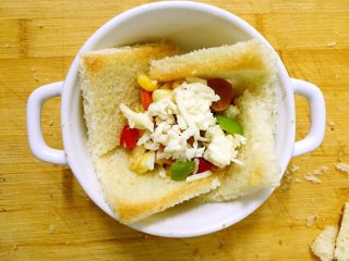 9、吐司披萨盏,在蔬菜丁上撒一层马苏里拉芝士碎。