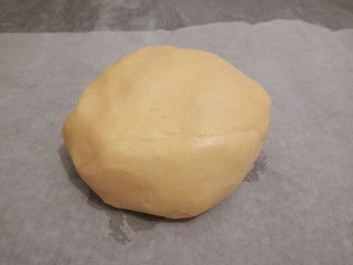 7、手工diy饼干,用橡皮刮刀,搅拌均匀,再用手给它揉成一个光滑的面团,放在油纸上