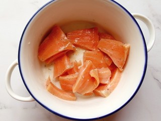 1、牛油果三文鱼米饭披萨,三文鱼切片用黑胡椒、盐和柠檬汁腌15分钟