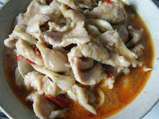 4、家常【水煮牛肉】,将煮好的肉片倒入容器里，将辣椒粉，花椒粉、大蒜撒在肉片上。