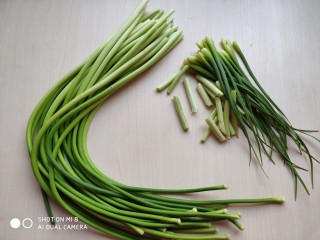 1、蒜薹炒豆腐,蒜薹去掉根部较老的部分和尾须，清洗干净。