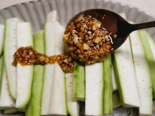 13、蒜蓉蒸丝瓜,将蒜蓉酱汁淋到丝瓜上面