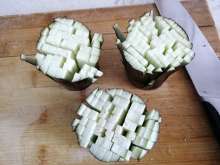 3、菊花茄子,然后将茄子段竖起来切小的十字刀，底部不切穿