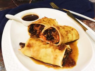 17、健康素食之豆腐皮卷素菜,然后把蒸熟的素菜卷码到盘子里，淋上芡汁即可食用