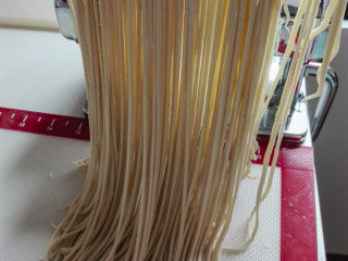 4、重庆小面,我用细刀口切成面条,喜欢吃宽面的,就切成宽的,这个看个人喜好了。切好的面条,撒一点玉米面放沾,或者用筷子架起来晾干。