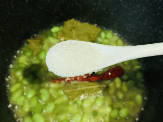 14、香辣毛豆,打开锅盖，加少许白糖；