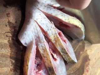 2、剁椒扁鱼,从背部改刀，加葱姜，料酒腌五分钟