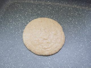 8、【燕麦香蕉Pancake】(素食低脂版),小火热锅，倒入一勺面糊，勺子保持不动让面糊自由倒入平底锅中，面糊会慢慢摊开成一个圆形。