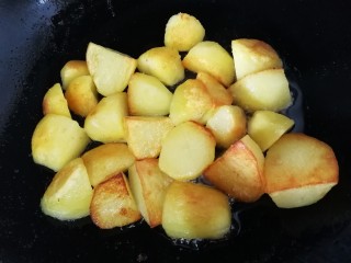 9、香酥小土豆,2分钟后挨着锅的那面土豆已经煎焦，给它翻个面，继续文火煎2分钟。