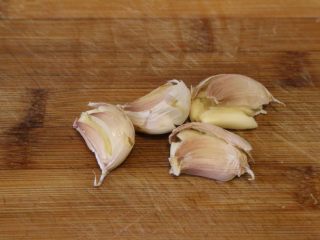 5、干烧萝卜,大蒜洗净表皮,用到连皮拍碎。