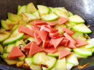 8、醋熘西葫芦,炒匀后加入方火腿片。