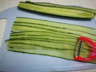 6、凉拌黄瓜卷,用刮皮刀刮成薄片