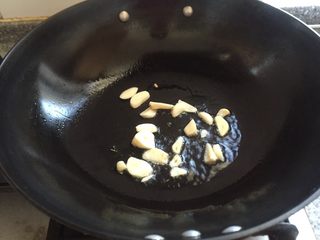 9、地方乡味菜头的几种吃法,锅中放入茶油烧七成热放入蒜片，马上放入菜头，我因为拍照会延误一会儿。