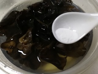 3、凉拌木耳,泡发好的木耳体积变大，加少许小苏打揉搓。