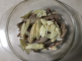 6、柠檬凤爪,鸡爪放入盆里、撒上蒜姜片。