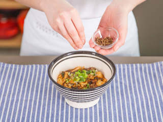 4、麻婆豆腐,盛到餐盘中,依喜好撒上四川花椒面和青葱。开始享用吧!