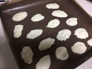 11、蓝天白云蛋糕卷,在铺了油纸的金盘里挤出云朵状，不要太规则随意就好，烤盘送进提前预热好的烤箱，上下火180度3分钟。