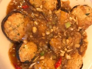 9、香菇酿肉,另起锅,倒入少量油烧热,放入葱姜蒜爆香,将煎香菇煎出的油汁倒入并加入少量水,烧开后加入少量水淀粉勾芡,然后将烧好的汁淋在香菇酿上即可享用了。