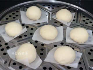 14、绵密香甜的流沙包,包子垫上防黏油纸，码放于蒸笼上，静置15分钟后打开火，大火蒸10分钟