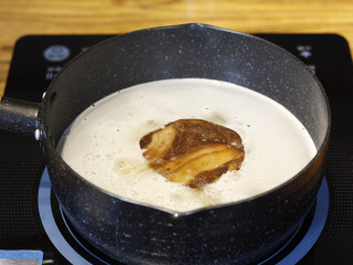 3、ラーメン，日料店必点的地狱拉面,放入一块冻干叉烧肉在汤锅中煮2分钟。 叉烧肉可直接购买冻干叉烧片，经骨汤煮后很好吃，也可以在家用五花肉自己卤。