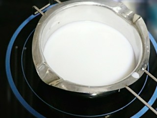 3、芒果糯米饭,牛奶，盐，糖，椰浆倒入小奶锅中，搅拌。小火加热到微微沸腾，糖融化。