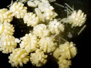 16、菊花捶鱼,待水冒小泡时,把蛋肠连同香菇和泡香菇水一同下入,(你会看到蛋肠变成一朵朵的小菊花了)