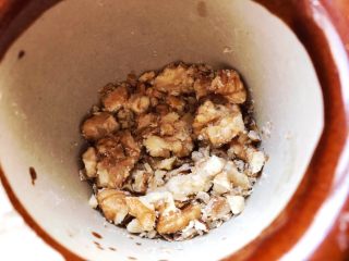 2、日式醇香核桃饭,核桃放入蒜臼中捣碎，没有的话，放入保鲜袋，用擀面杖敲碎也可以。保留一些颗粒，这样口感更好。