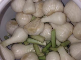 5、家庭腌糖蒜,由于第一次做，蒜和糖醋水的量没掌握好，导致一个坛子放不下蒜，没办法，把剩下的蒜又放在一个小坛子里。又兑了点糖醋水。这小半坛子蒜又用了两袋醋和约300克糖(家里盛汤的大平勺约1.5勺)。放阴凉处搁置。过段时间再发成品图。