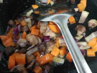 5、抓饭,炒到肉断生，把胡萝卜块和洋葱丁切倒锅里炒一下，放盐，适当多放些盐