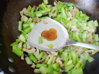 8、芹菜炒肉,加入蚝油。