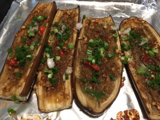 4、烤箱版烤茄子,最后放上孜然粉、辣椒、葱，再刷点油，烤1分钟，出锅，太好吃了，以后在家里也能吃上卫生干净的烤茄子