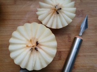 2、冰糖雪梨盅,梨洗净晾干水分，用刻刀在三分之一处切开（没有花刀可以用刀在三分之一处直接切开）