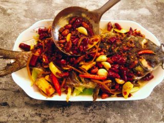 21、香辣烤鱼,将炒好的香辣汁均匀的淋在鱼上。