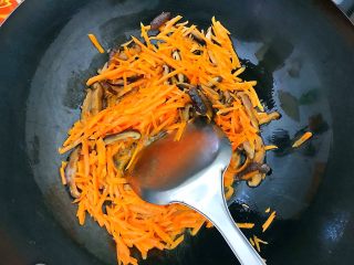 8、家常蚝油小炒三丝,倒入胡萝卜丝和花菇丝,翻炒至胡萝卜变软!