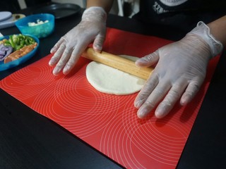 8、独家秘制香肠披萨,松弛好的面团，擀压成饼状。